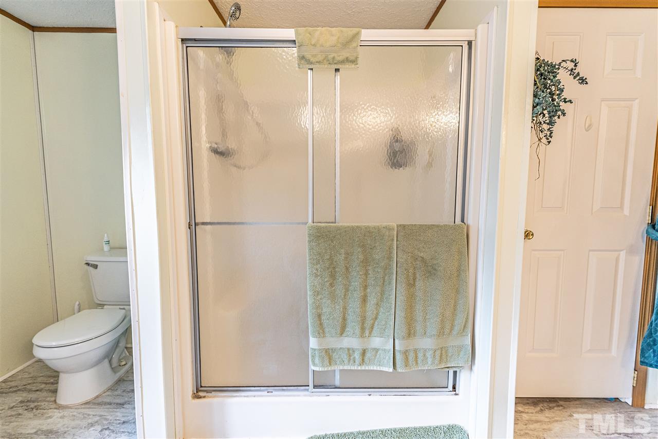 72 Cypress Farm Road Cameron, NC 28326 - Photo 19 of 28 a bathroom with a granite countertop shower and a toilet