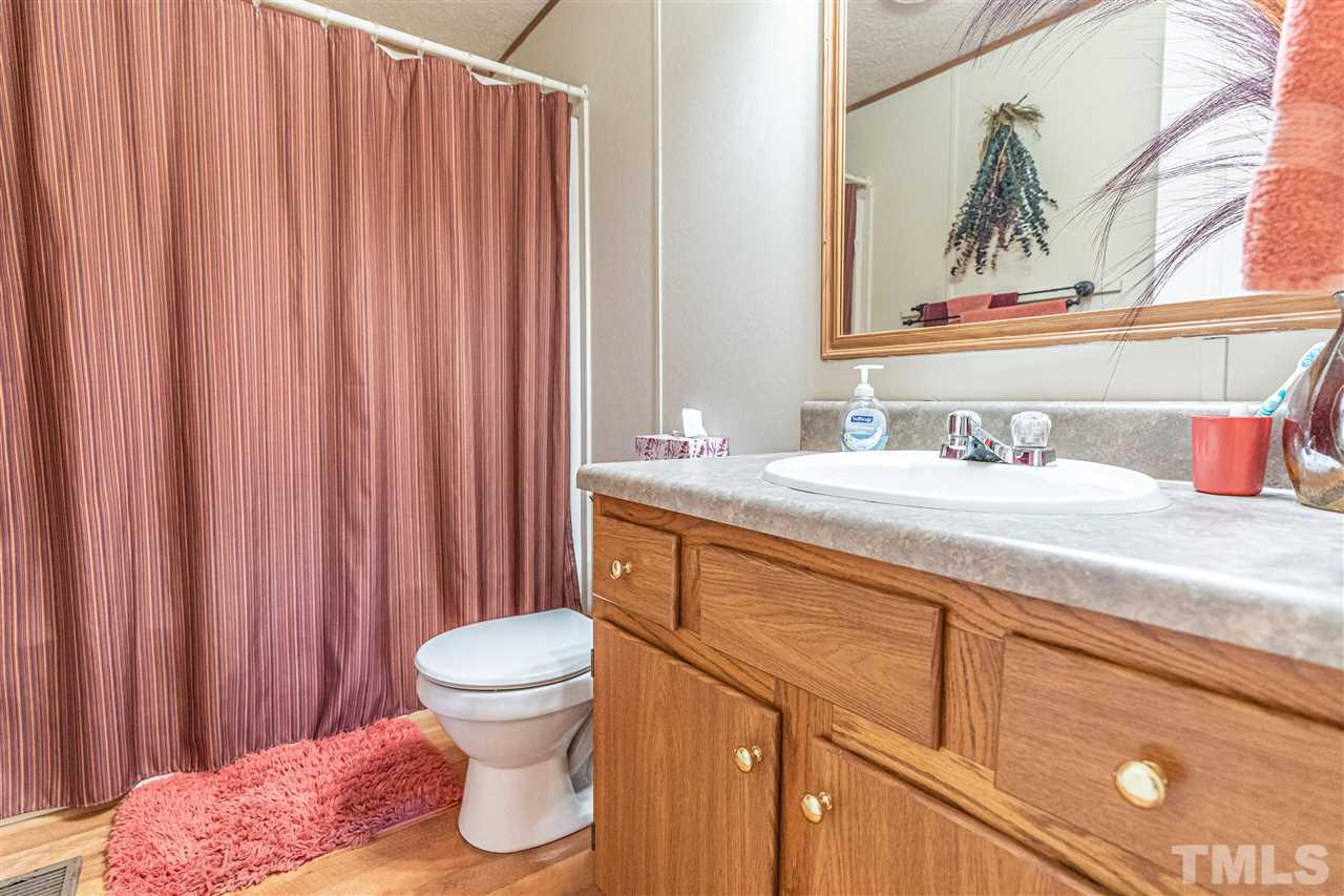 72 Cypress Farm Road Cameron, NC 28326 - Photo 20 of 28 a bathroom with a sink a toilet and a mirror
