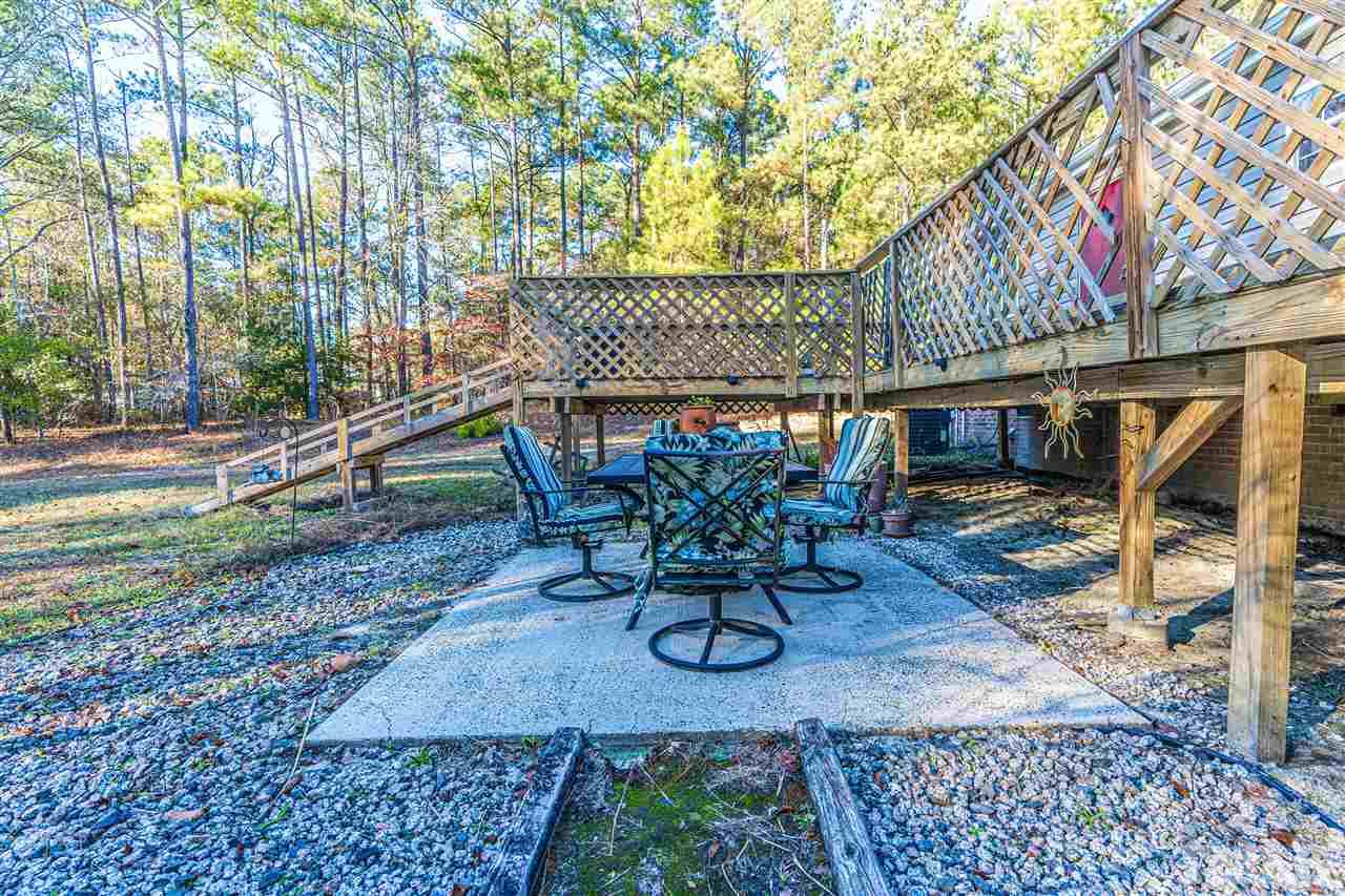 72 Cypress Farm Road Cameron, NC 28326 - Photo 22 of 28 a view of a backyard with table and chairs