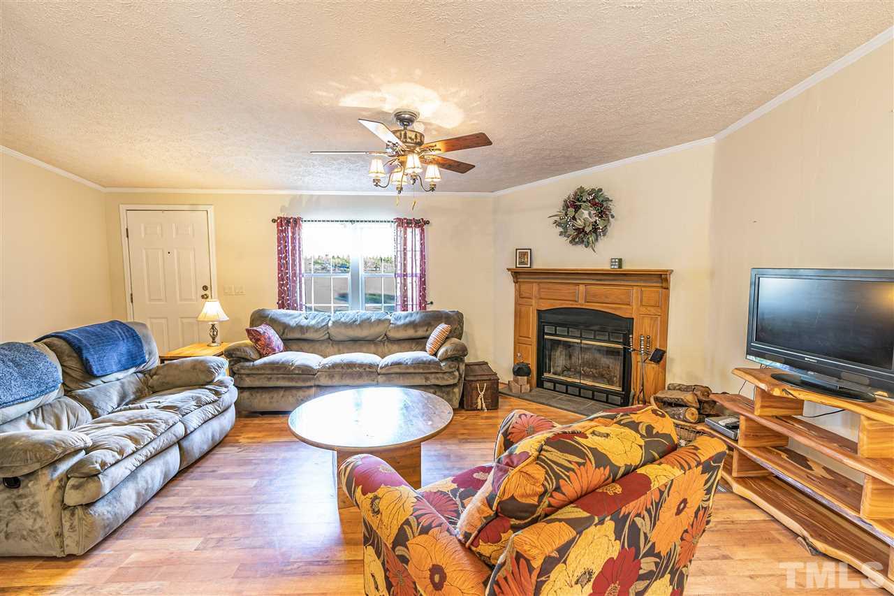 72 Cypress Farm Road Cameron, NC 28326 - Photo 5 of 28 a living room with furniture a fireplace and a flat screen tv