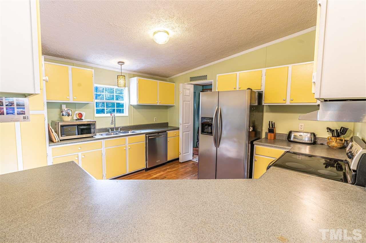 72 Cypress Farm Road Cameron, NC 28326 - Photo 7 of 28 a kitchen with stainless steel appliances a refrigerator sink and cabinets