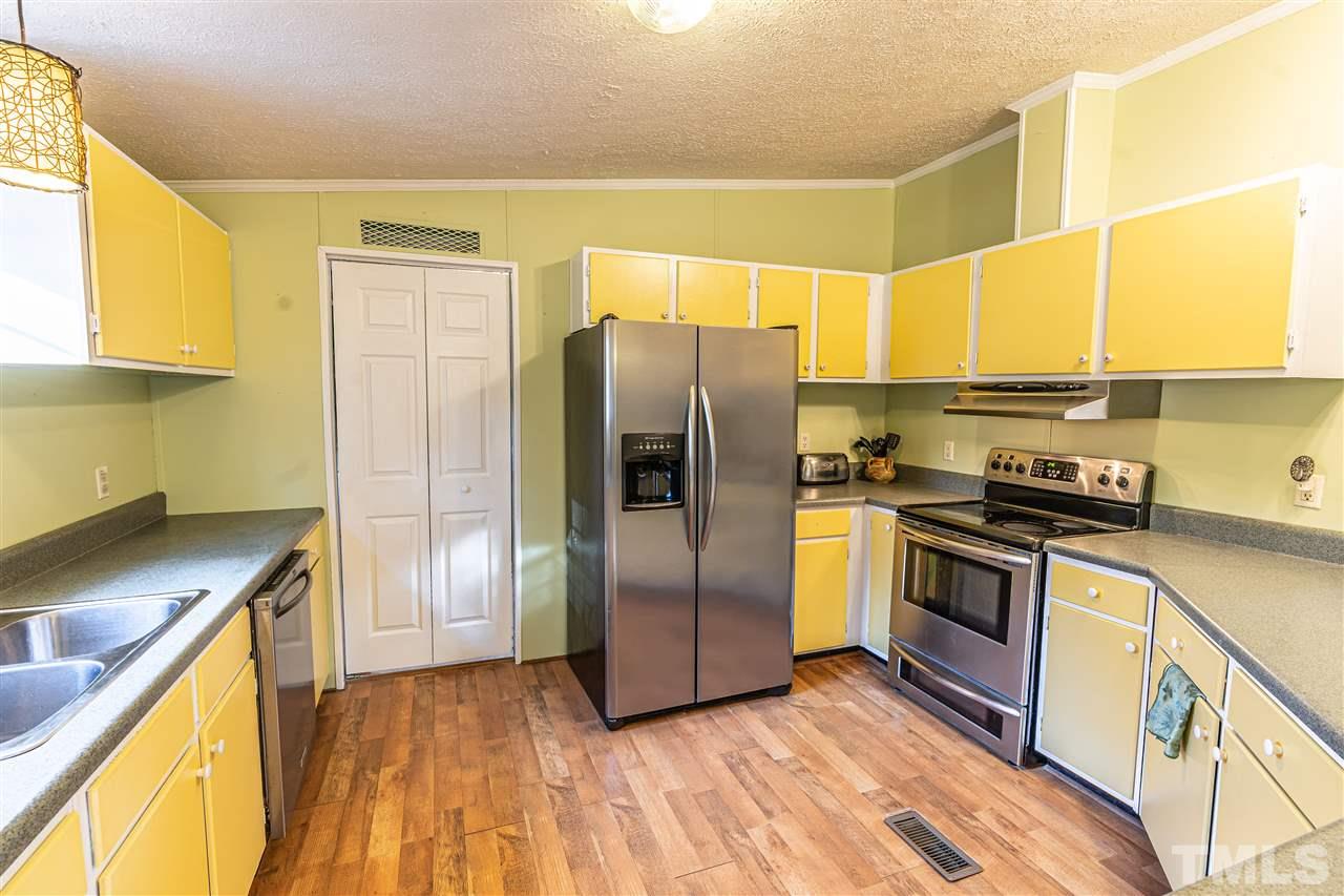 72 Cypress Farm Road Cameron, NC 28326 - Photo 8 of 28 a kitchen with granite countertop a refrigerator and a stove
