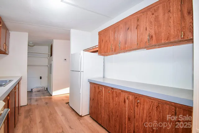 an empty room with wooden floor and window