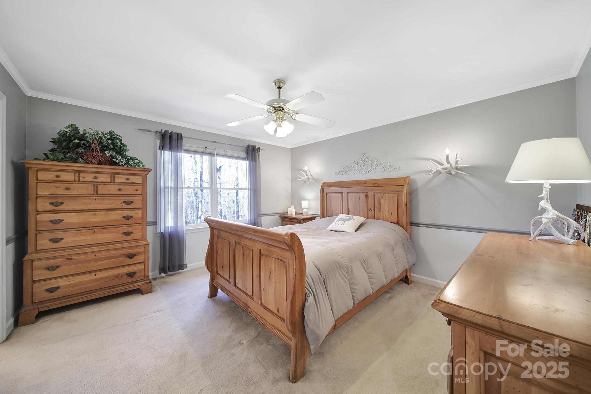 4289 Falcon Hall Way Rock Hill, SC 29730 - Photo 14 of 22 a bedroom with a bed and a chandelier