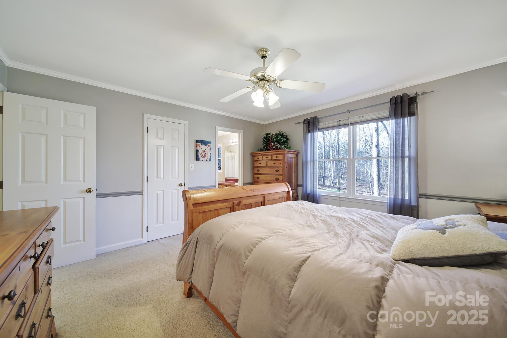 4289 Falcon Hall Way Rock Hill, SC 29730 - Photo 15 of 22 a bedroom with a large bed and a chandelier