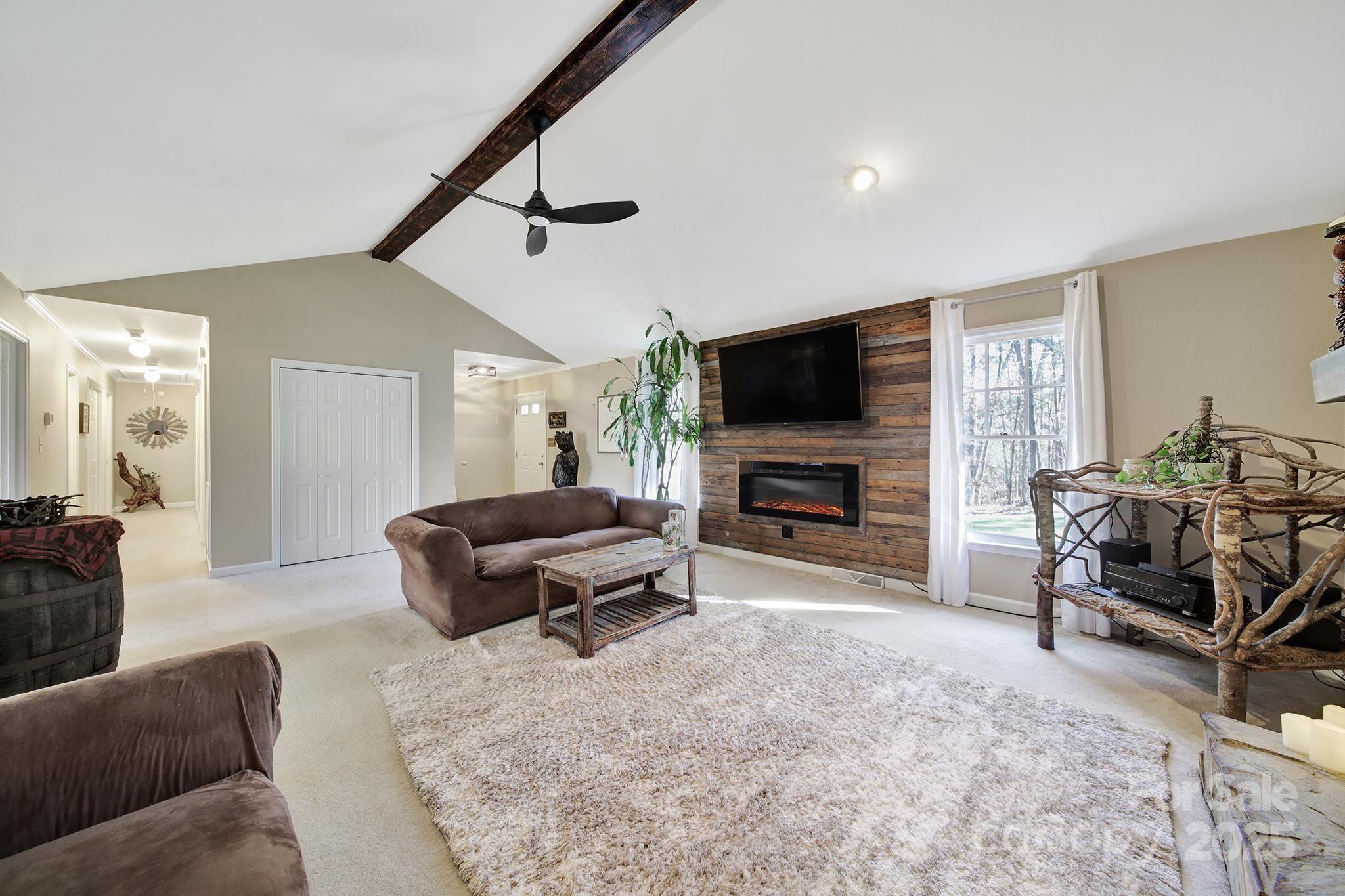4289 Falcon Hall Way Rock Hill, SC 29730 - Photo 6 of 22 a living room with furniture a flat screen tv and a fireplace