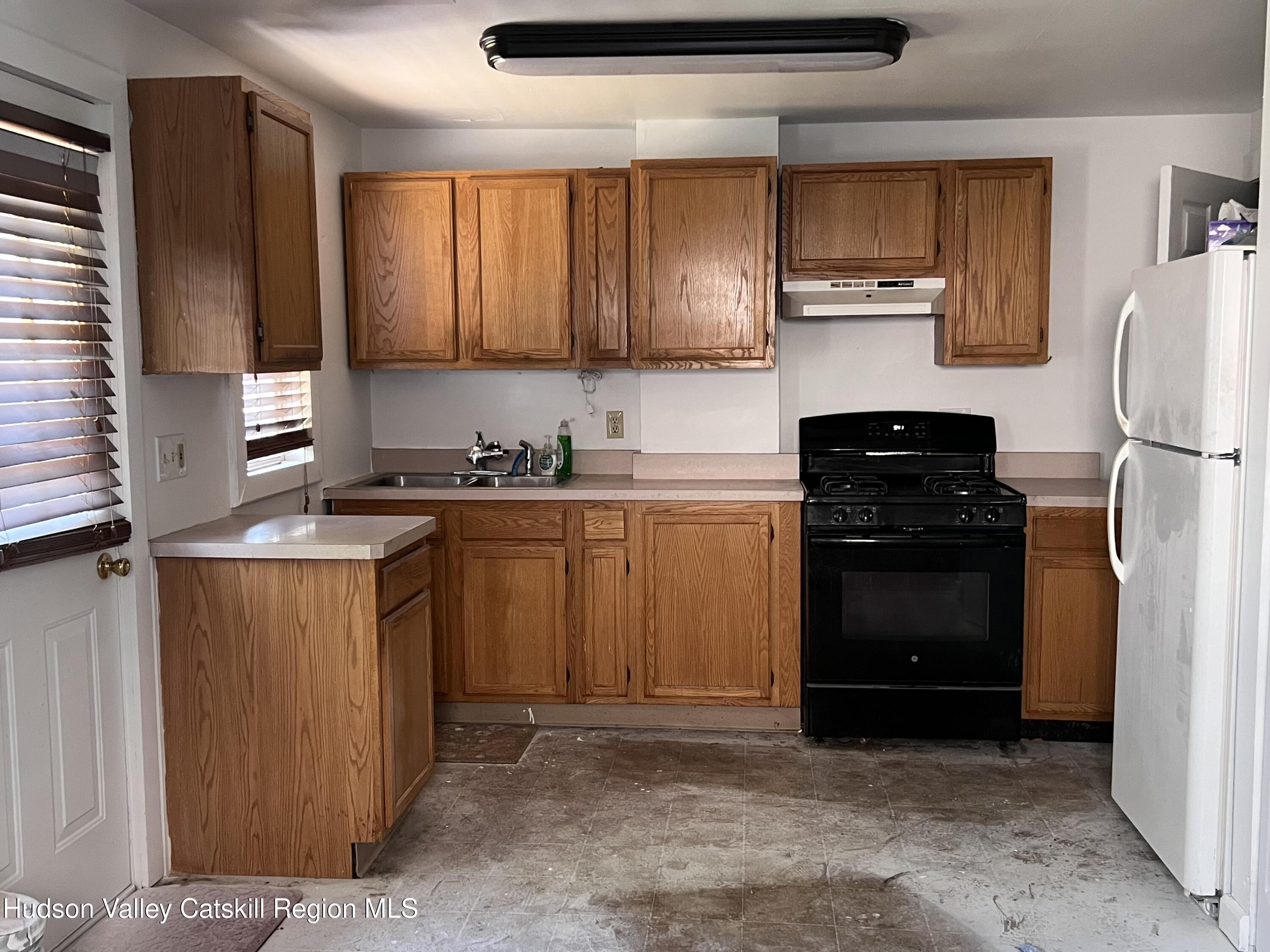 7 Berry Street Wallkill, NY 12589 - Photo 5 of 7 a kitchen with a sink stove and refrigerator