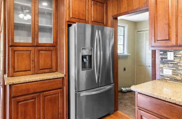 a kitchen with stainless steel appliances granite countertop a refrigerator and a sink