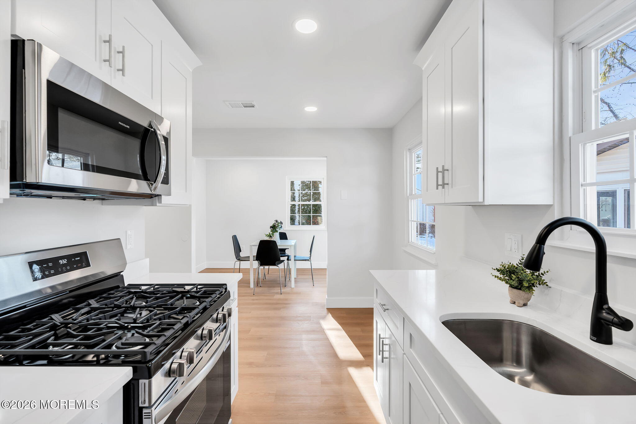 5 Jaffreyton Close Freehold, NJ 07728 - Photo 11 of 22 a kitchen with stainless steel appliances a stove a sink a microwave and cabinets