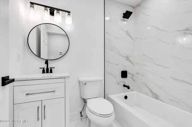 a bathroom with a sink a toilet and a bathtub