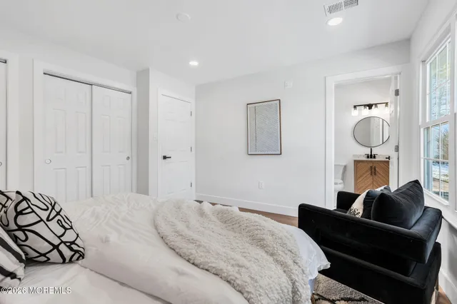 a bedroom with furniture and a painting