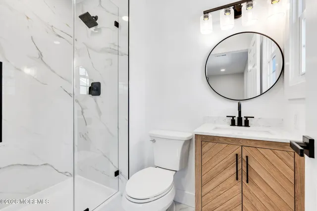 a bathroom with a toilet a sink and a shower