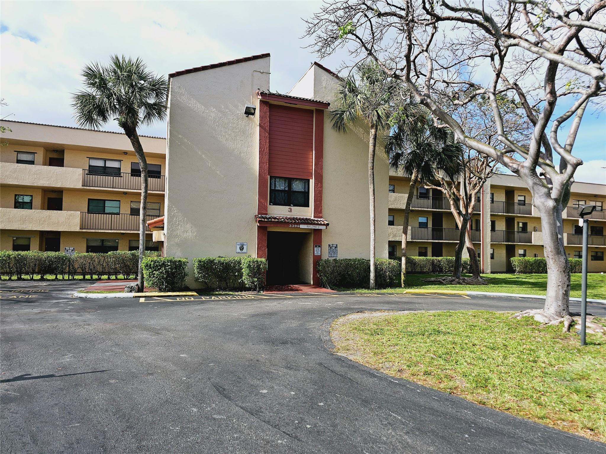3396 Foxcroft Road, Unit 110 Miramar, FL 33025 - Photo 1 of 24 front view of a building with a yard