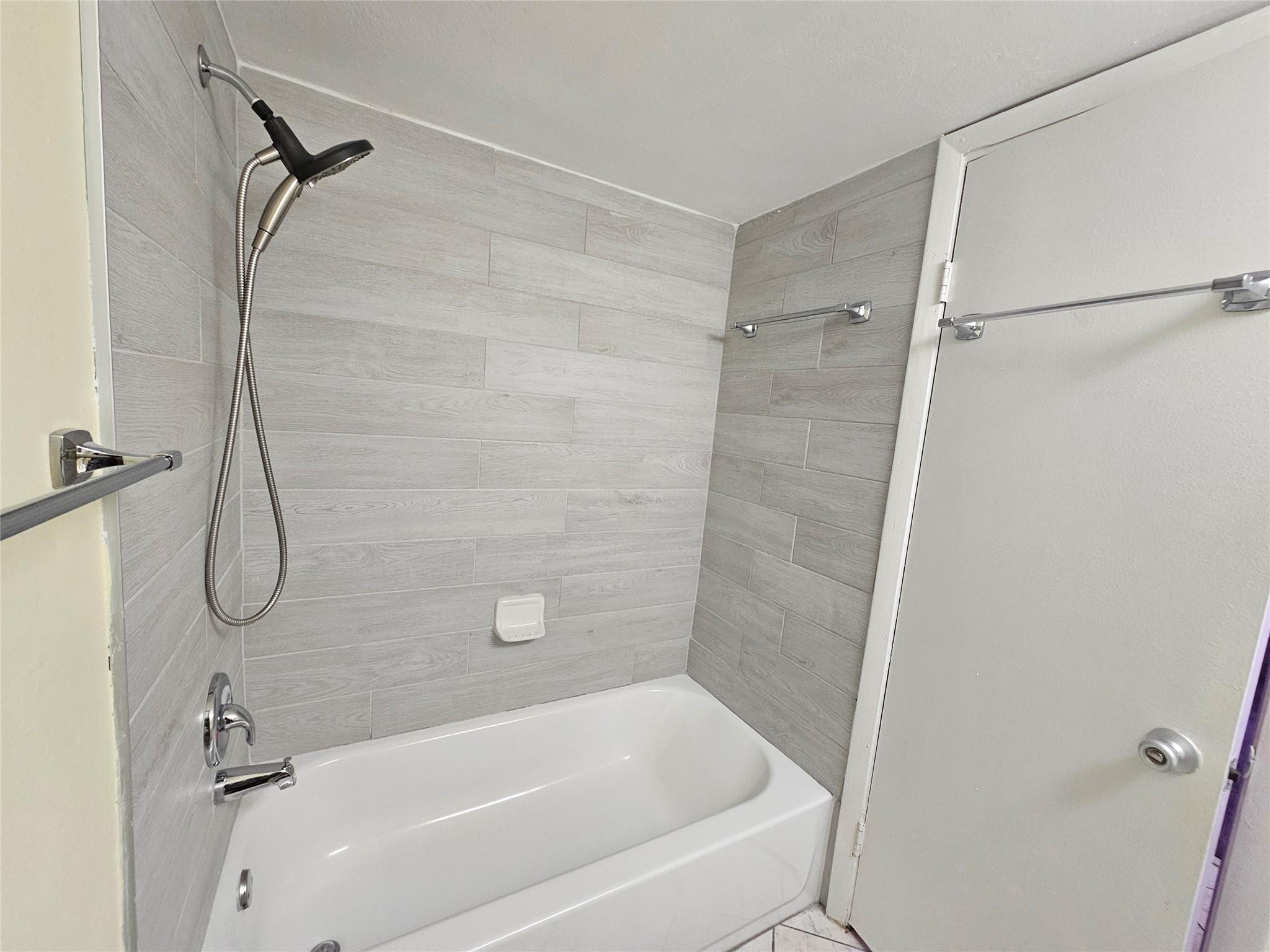 3396 Foxcroft Road, Unit 110 Miramar, FL 33025 - Photo 15 of 24 a bathroom with a bath tub with a shower