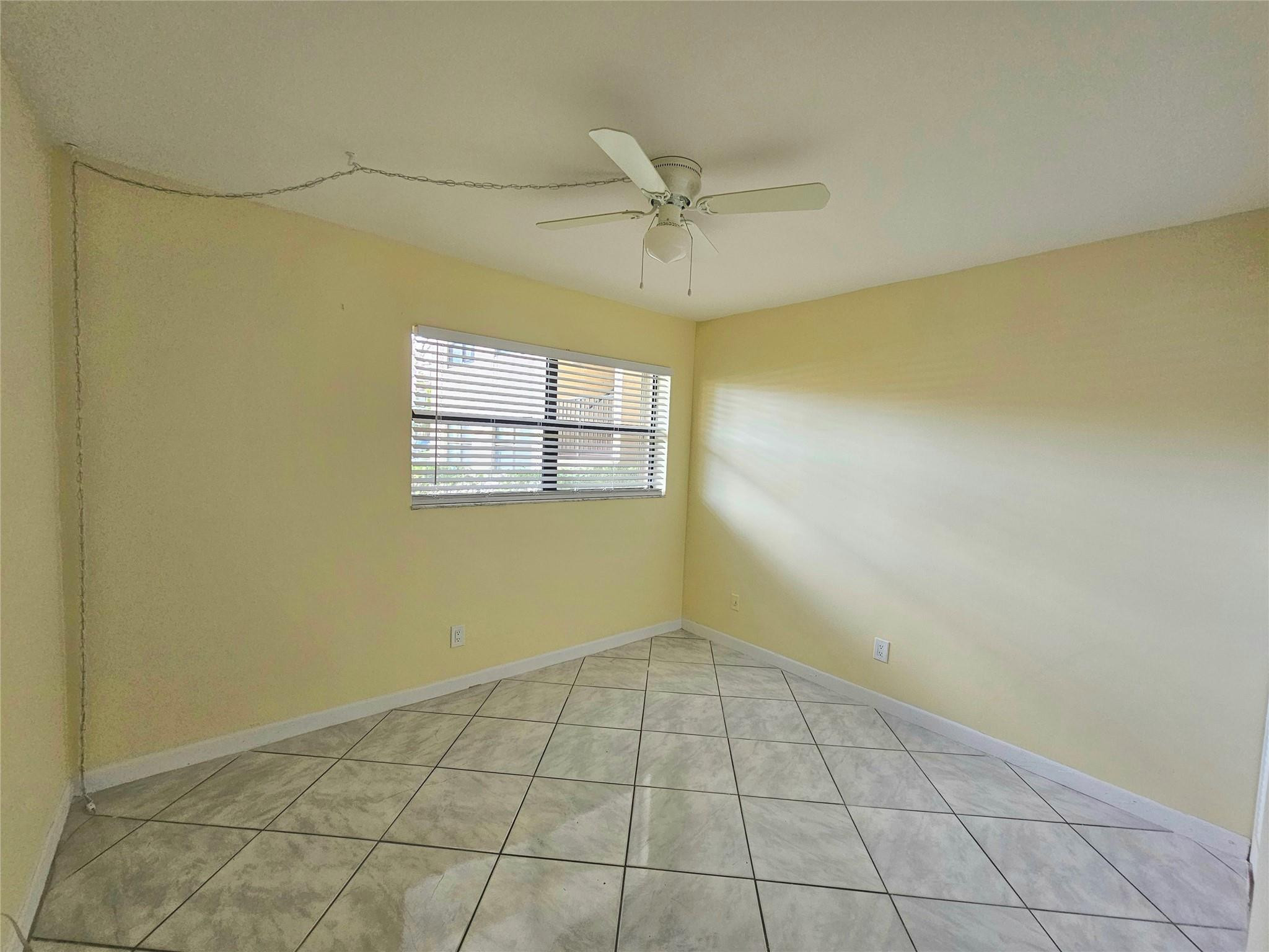 3396 Foxcroft Road, Unit 110 Miramar, FL 33025 - Photo 16 of 24 an empty room with windows and fan