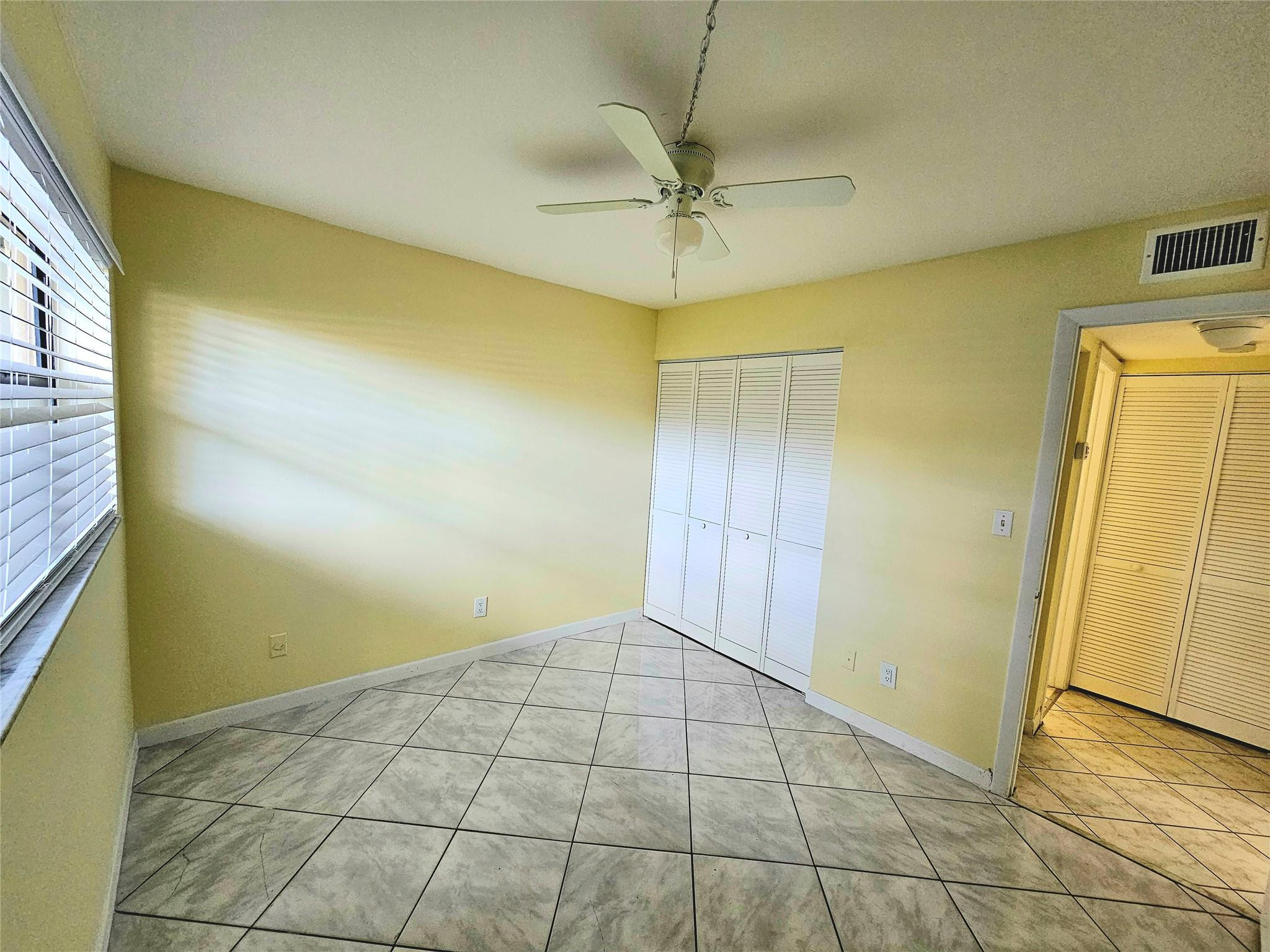 3396 Foxcroft Road, Unit 110 Miramar, FL 33025 - Photo 17 of 24 a view of an empty room with a window