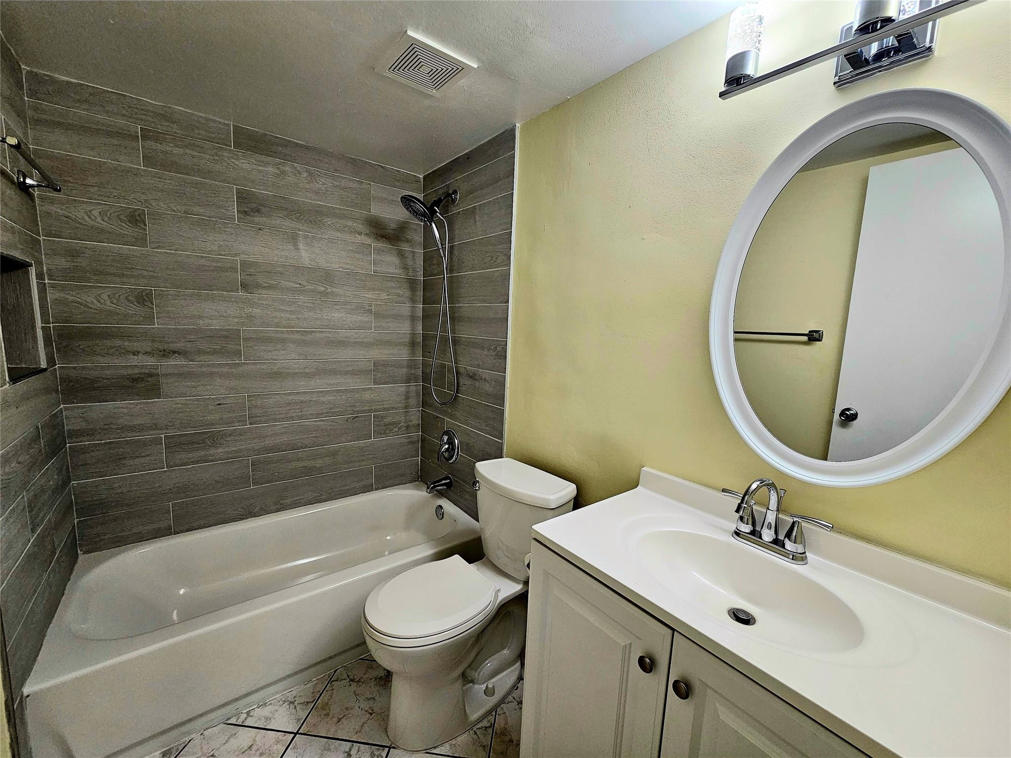 3396 Foxcroft Road, Unit 110 Miramar, FL 33025 - Photo 19 of 24 a bathroom with a sink a toilet and a mirror