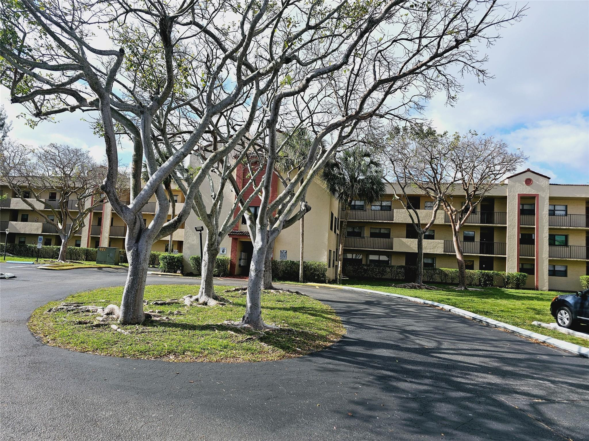 3396 Foxcroft Road, Unit 110 Miramar, FL 33025 - Photo 2 of 24 a front view of a house with a yard