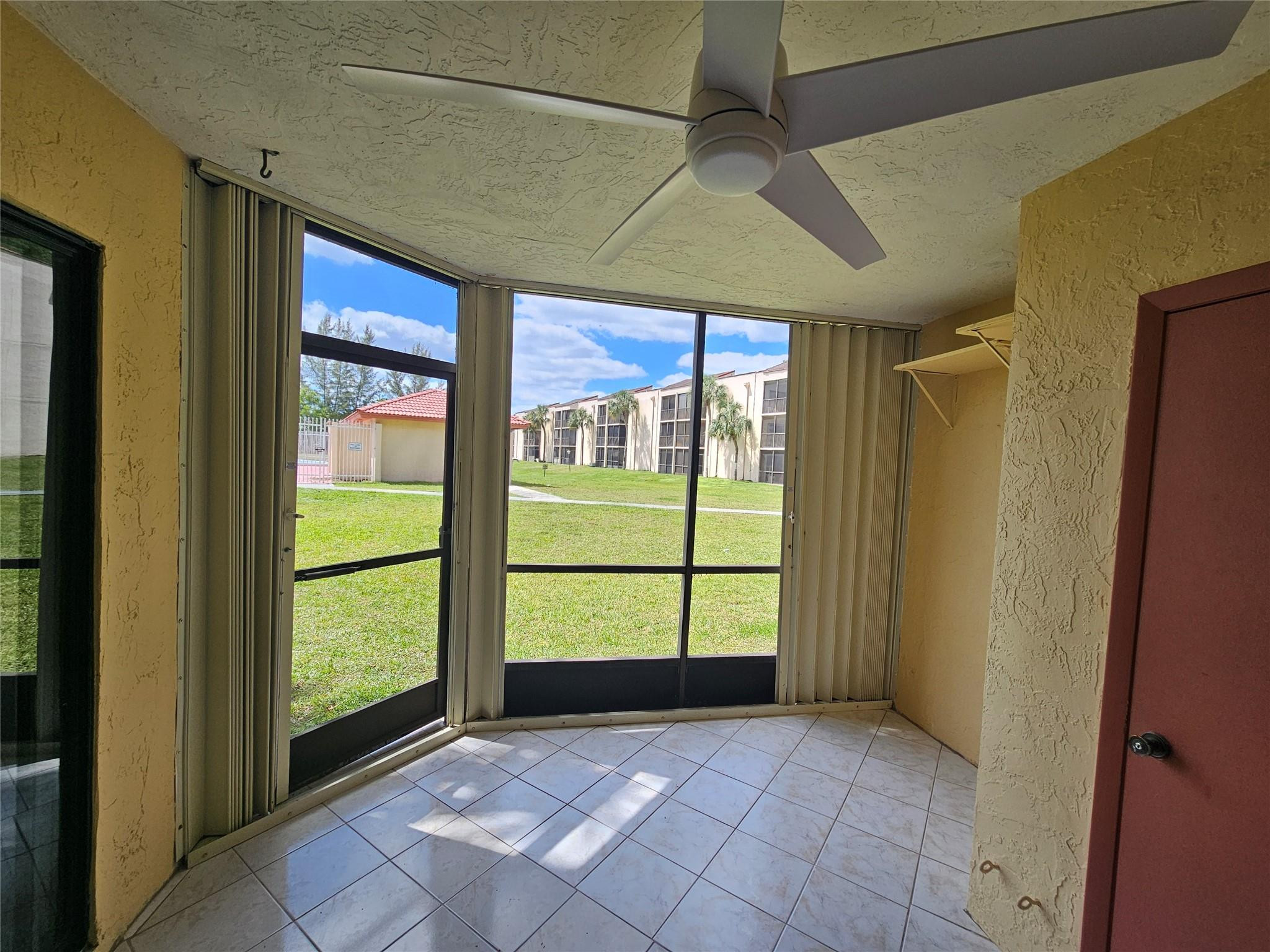 3396 Foxcroft Road, Unit 110 Miramar, FL 33025 - Photo 22 of 24 a view of entryway with a floor to ceiling window and front door