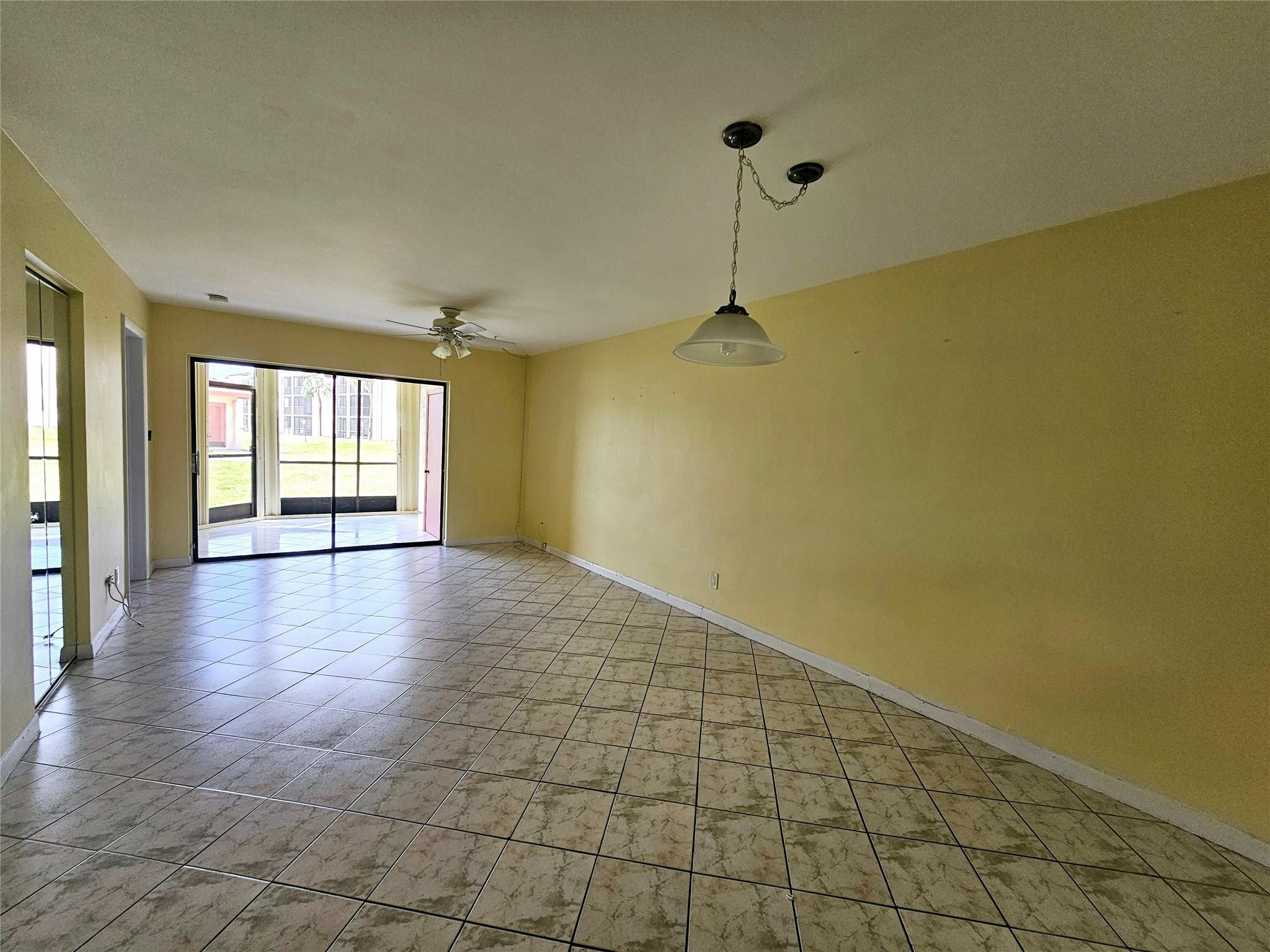 3396 Foxcroft Road, Unit 110 Miramar, FL 33025 - Photo 4 of 24 a view of an empty room with a window