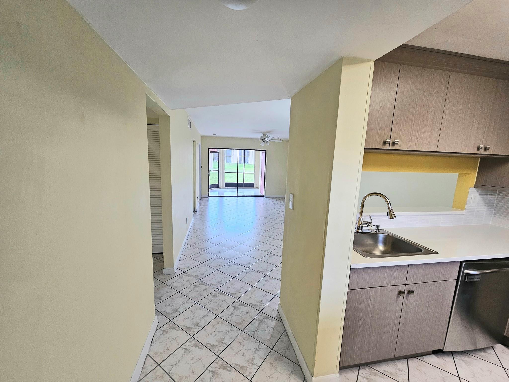 3396 Foxcroft Road, Unit 110 Miramar, FL 33025 - Photo 6 of 24 a kitchen with a sink and cabinets