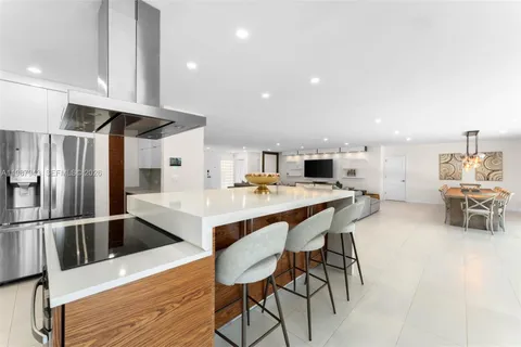 a kitchen with stainless steel appliances kitchen island granite countertop a sink and cabinets