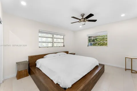 a bed sitting in a bedroom next to a window