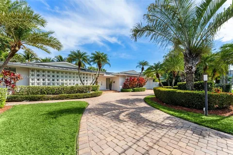 a front view of a house with a garden and a yard