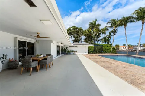 a view of a patio with table and chairs and potted plants