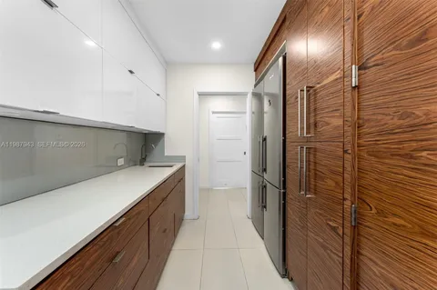 a kitchen with a sink and refrigerator