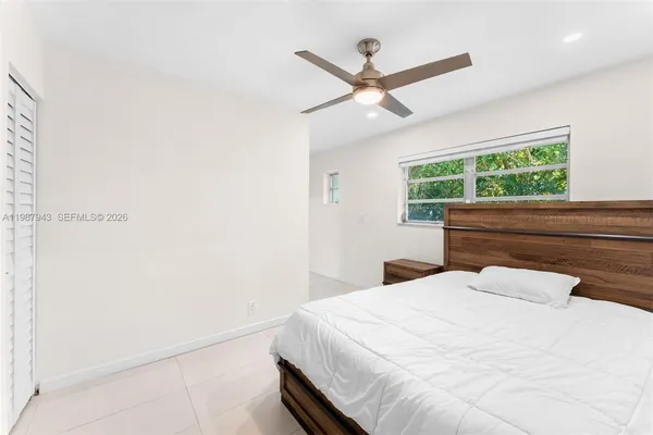 a bedroom with a large bed and a large window