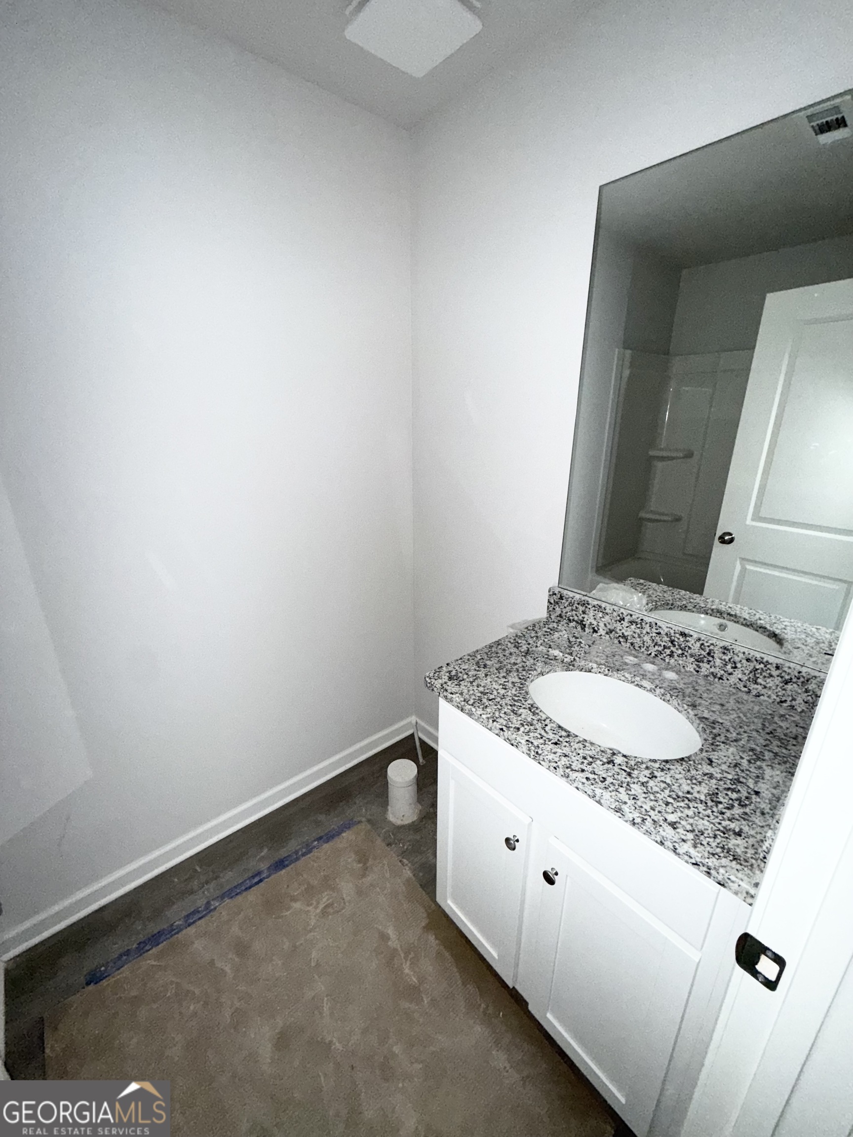 11604 East Lovejoy Road Hampton, GA 30228 - Photo 18 of 22 a bathroom with a granite countertop sink and a mirror