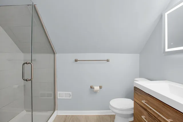 a bathroom with a granite countertop bathtub shower and toilet