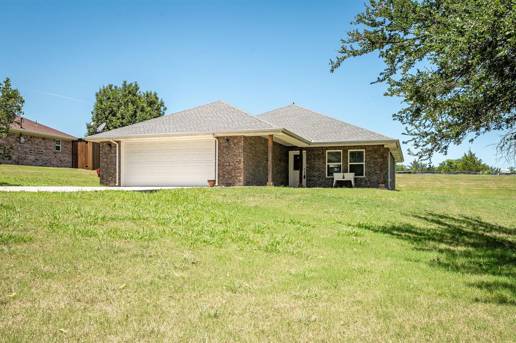 219 Ridgetop Court Blue Ridge, TX 75424 - Photo 1 of 1 Ranch-style house featuring roof with shingles, an attached garage, brick siding, a front lawn, and driveway