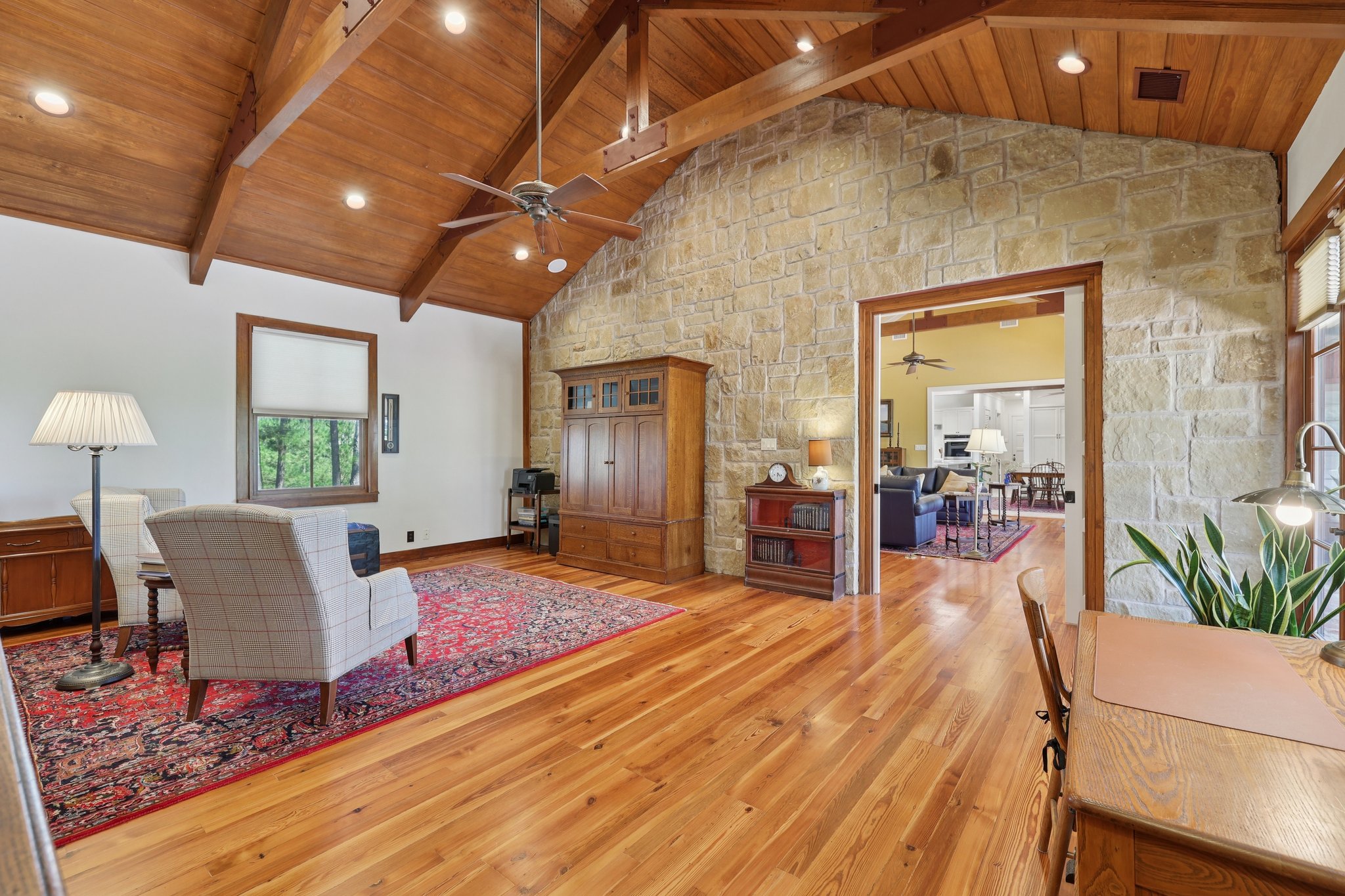 546 McAllister Road Bastrop, TX 78602 - Photo 12 of 40 Living area with light wood-style flooring, a ceiling fan, a high wood beamed ceiling, and recessed lighting