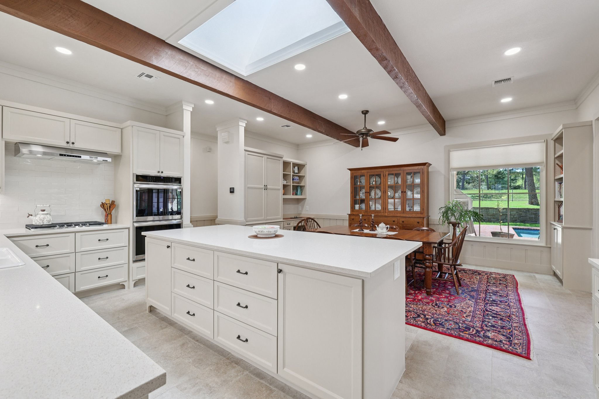 546 McAllister Road Bastrop, TX 78602 - Photo 13 of 40 Kitchen featuring backsplash, recessed lighting, a kitchen island, white cabinetry, and stainless steel appliances