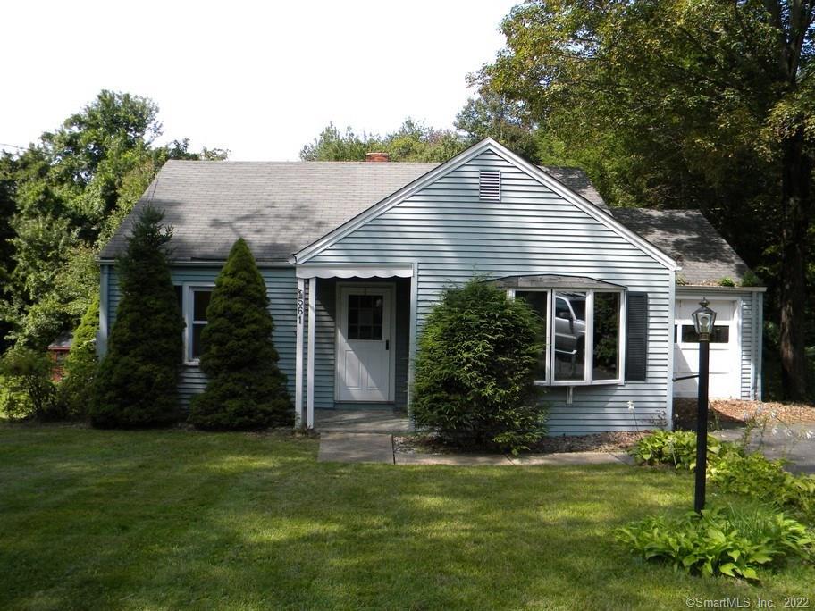 a front view of a house with a yard and porch