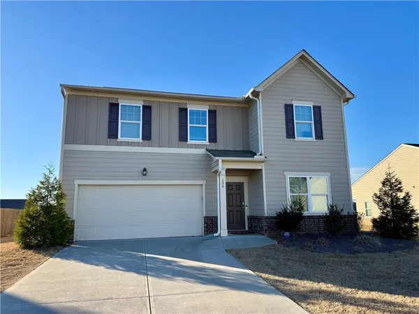 a front view of a house with a yard