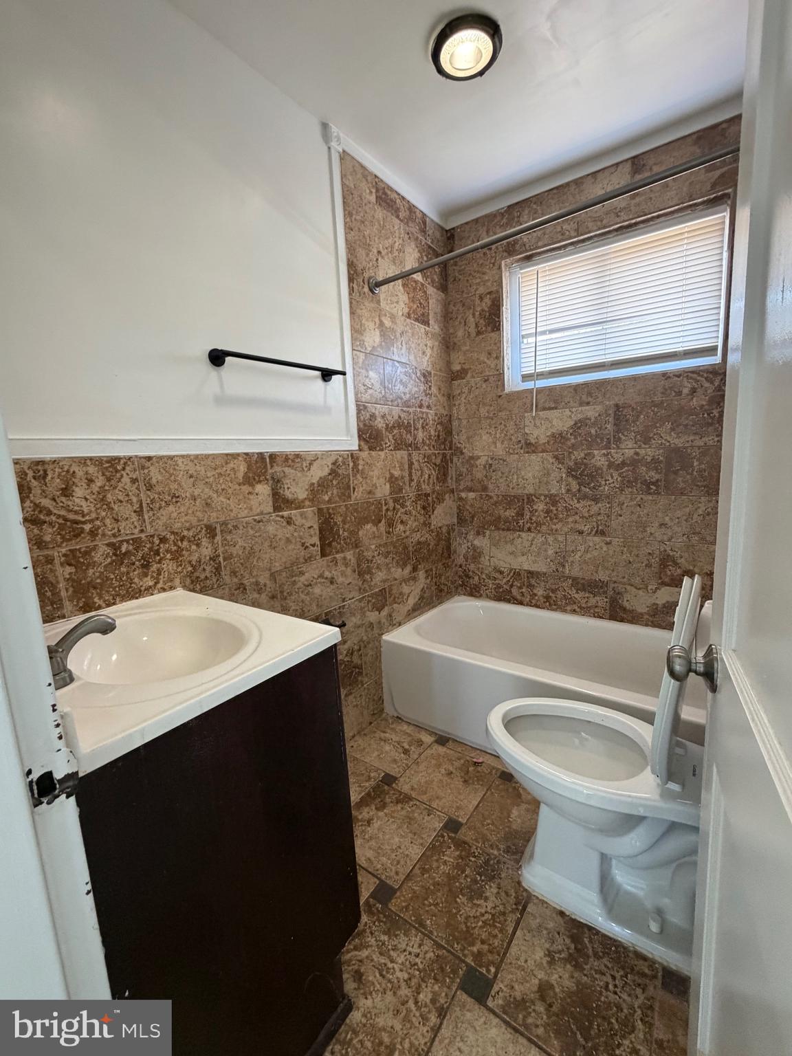 1626 Inverness Avenue Baltimore, MD 21230 - Photo 8 of 19 a bathroom with a sink a toilet a mirror and bathtub