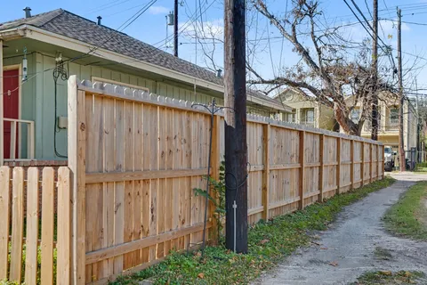 a view of a house with wooden fence