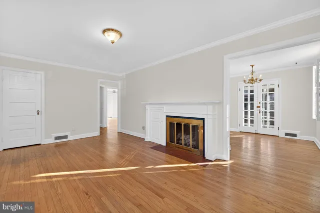 a view of empty room with wooden floor and fireplace