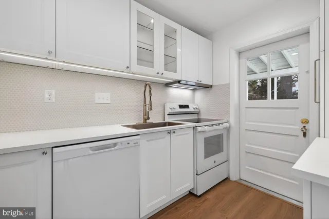 a kitchen with stainless steel appliances granite countertop a sink and cabinets