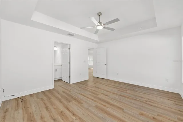 a view of an empty room and wooden floor