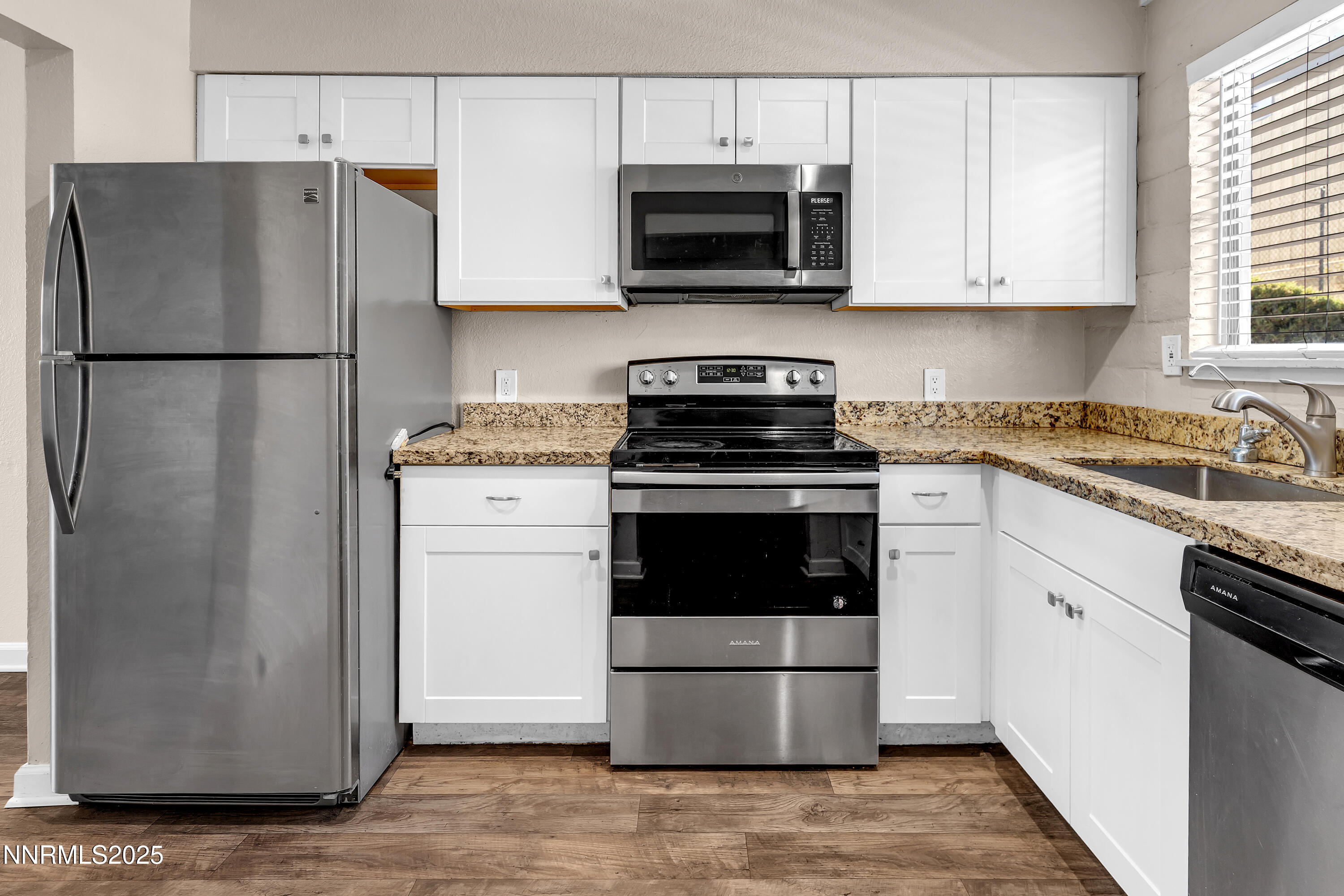 1436 East 9th Street, Unit 8 Reno, NV 89512 - Photo 12 of 19 a kitchen with a stove microwave and refrigerator