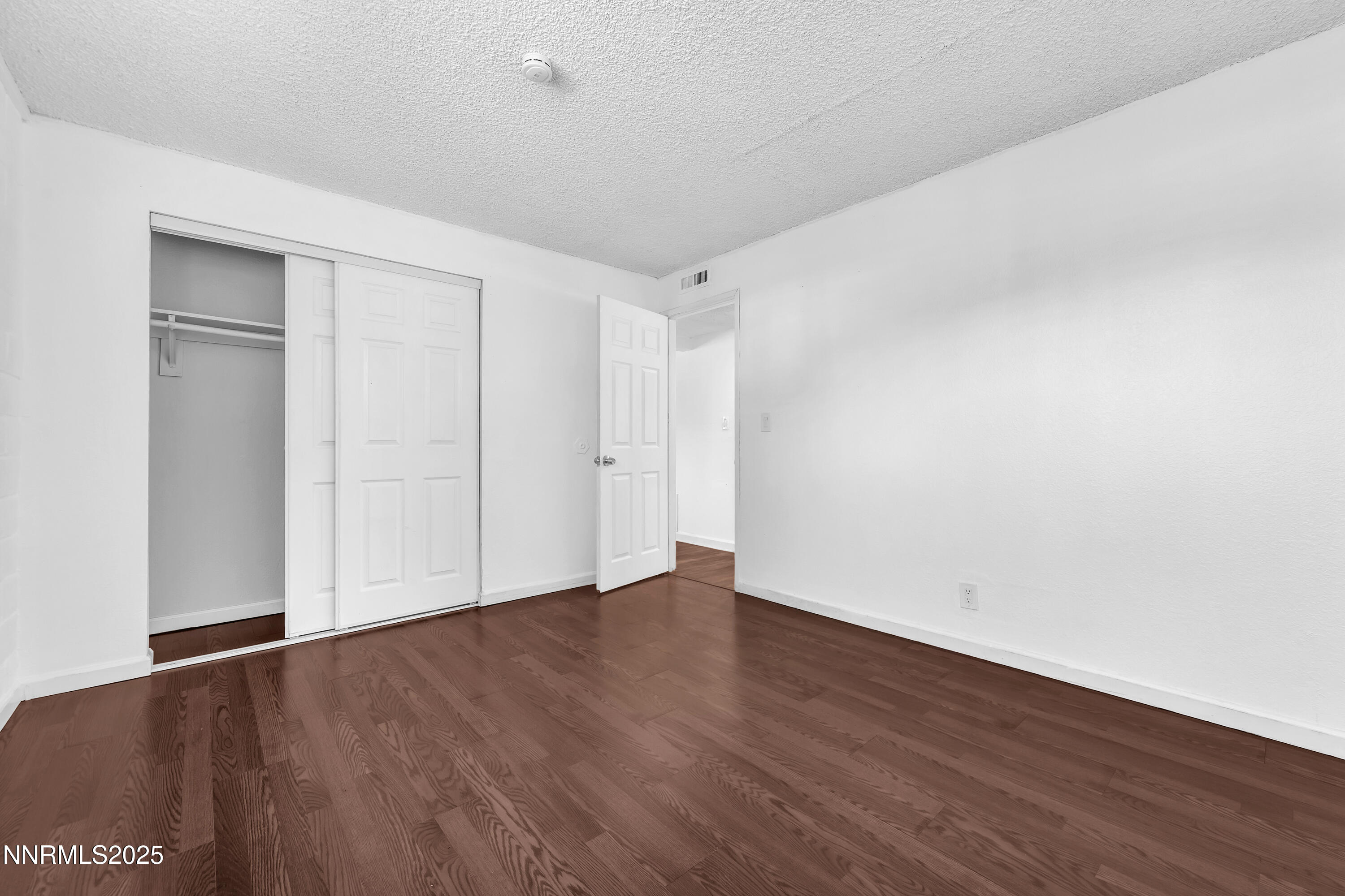 1436 East 9th Street, Unit 8 Reno, NV 89512 - Photo 13 of 19 a view of an empty room with wooden floor and closet