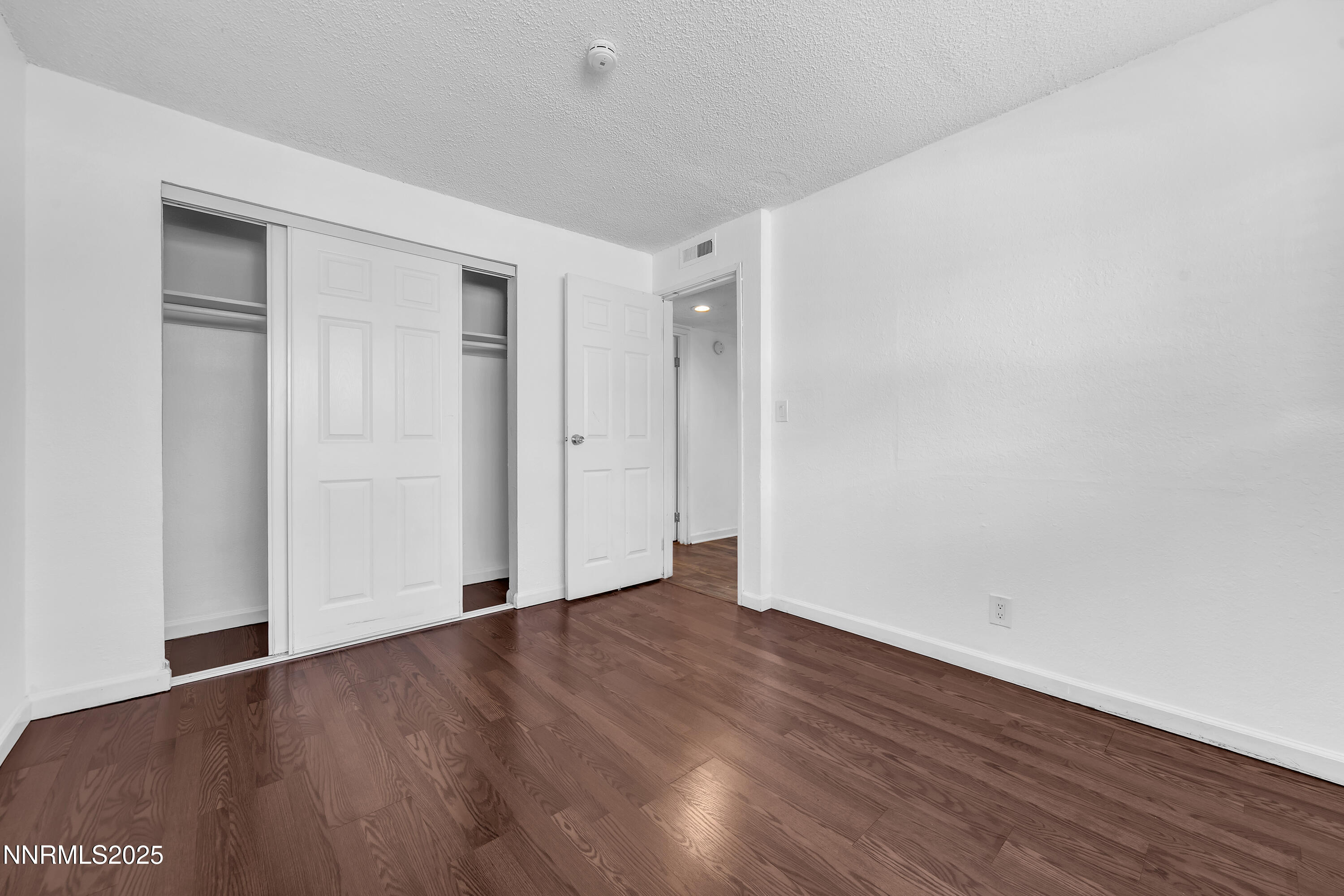 1436 East 9th Street, Unit 8 Reno, NV 89512 - Photo 15 of 19 a view of an empty room with wooden floor