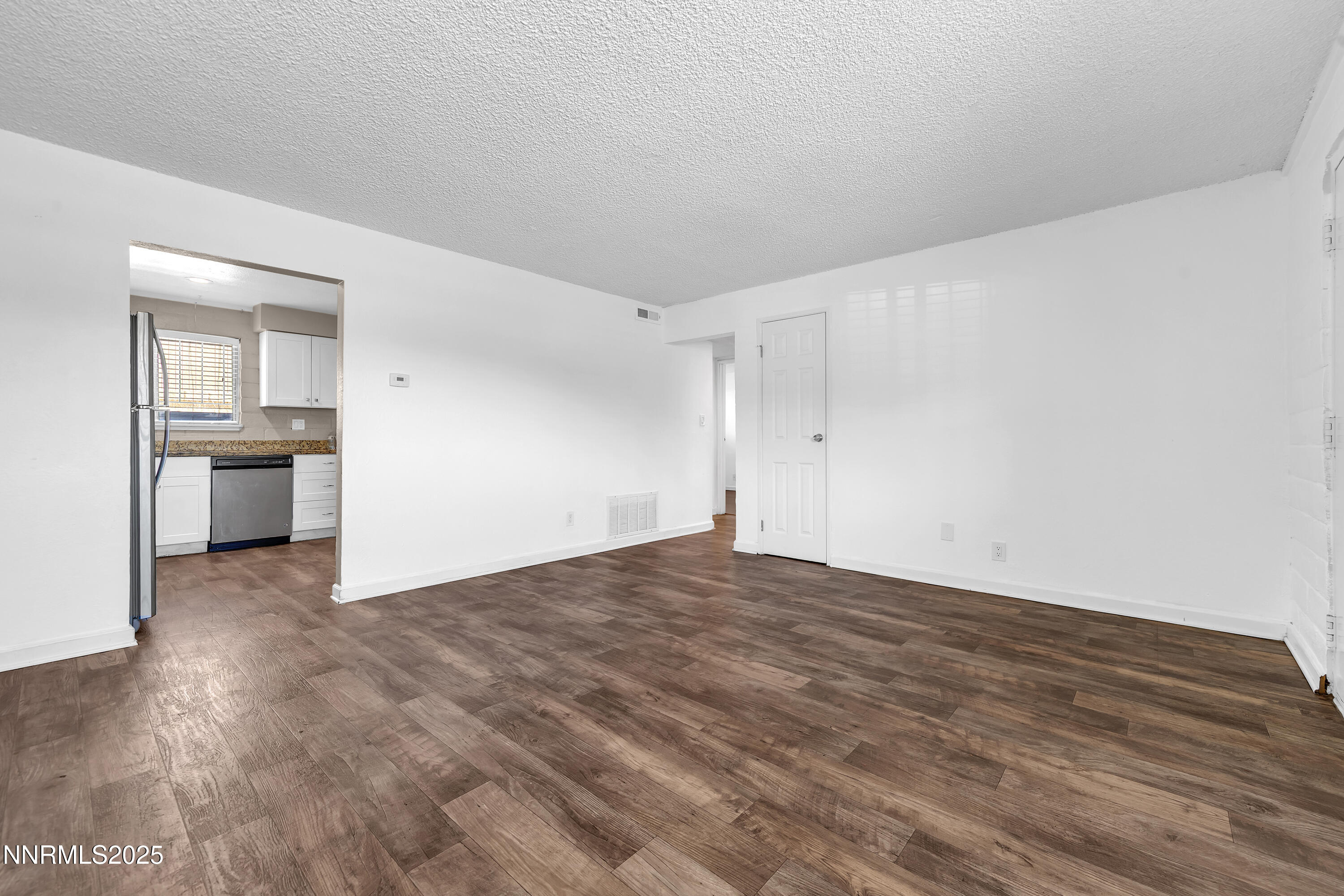 1436 East 9th Street, Unit 8 Reno, NV 89512 - Photo 5 of 19 a view of empty room with kitchen