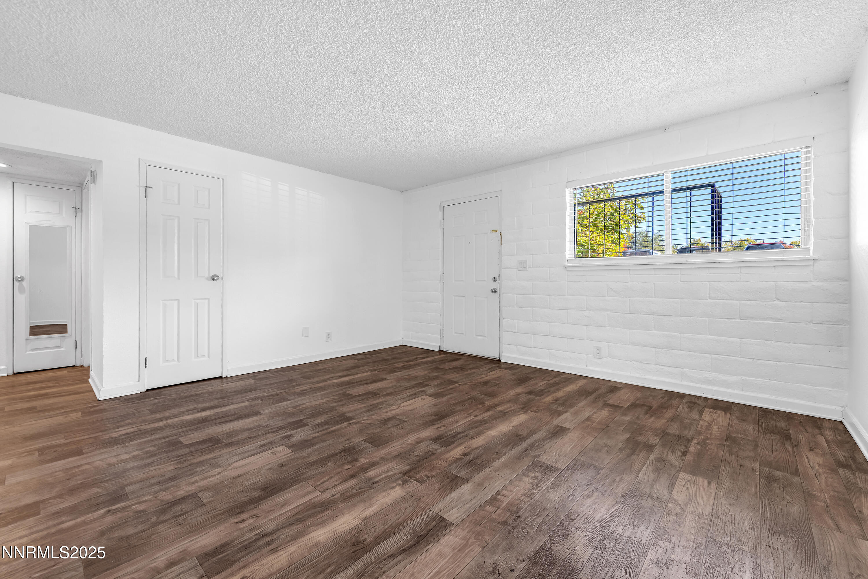 1436 East 9th Street, Unit 8 Reno, NV 89512 - Photo 6 of 19 a view of empty room with wooden floor and ceiling fan
