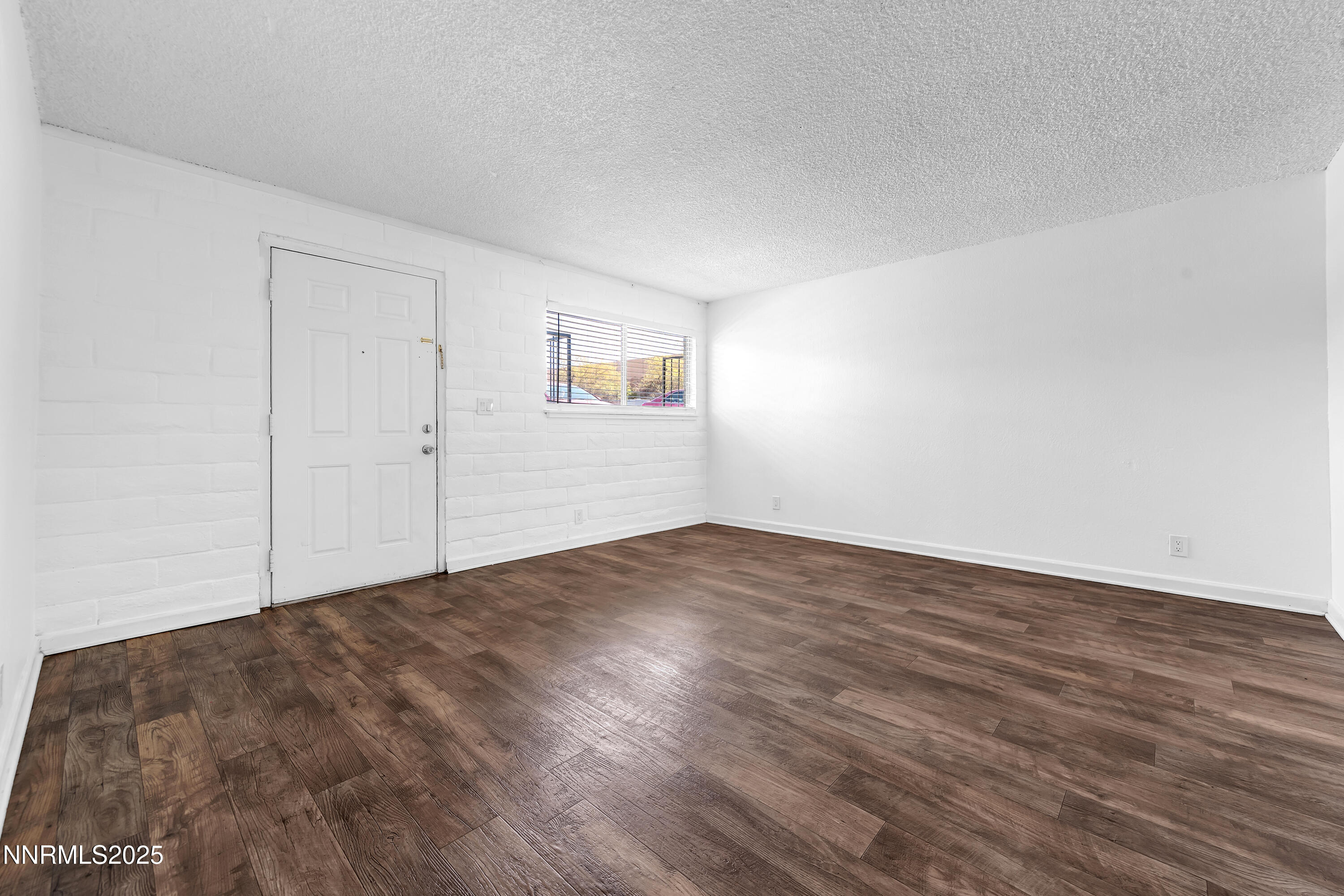 1436 East 9th Street, Unit 8 Reno, NV 89512 - Photo 7 of 19 a view of empty room with wooden floor