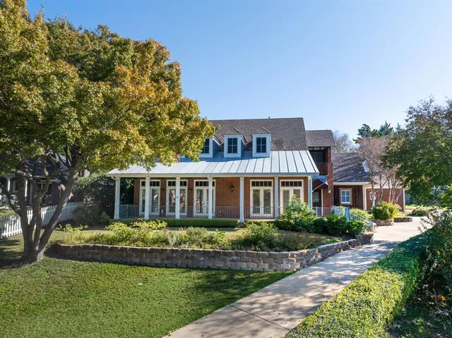 a front view of a house with a yard table and chairs